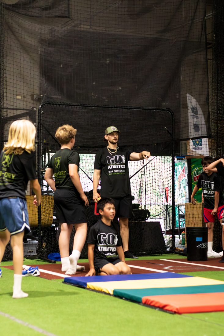 Coach instructing athletes at an Arm-ory training session